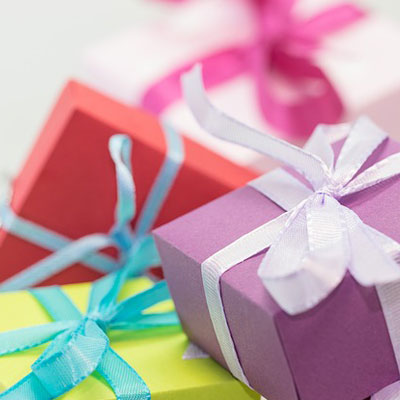 Colorful wrapped gifts with ribbon. Gift list for wedding anniversary gifts by year.