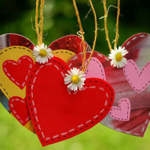 Hanging hearts with daisies. Happy anniversary greeting messages.r a couple.