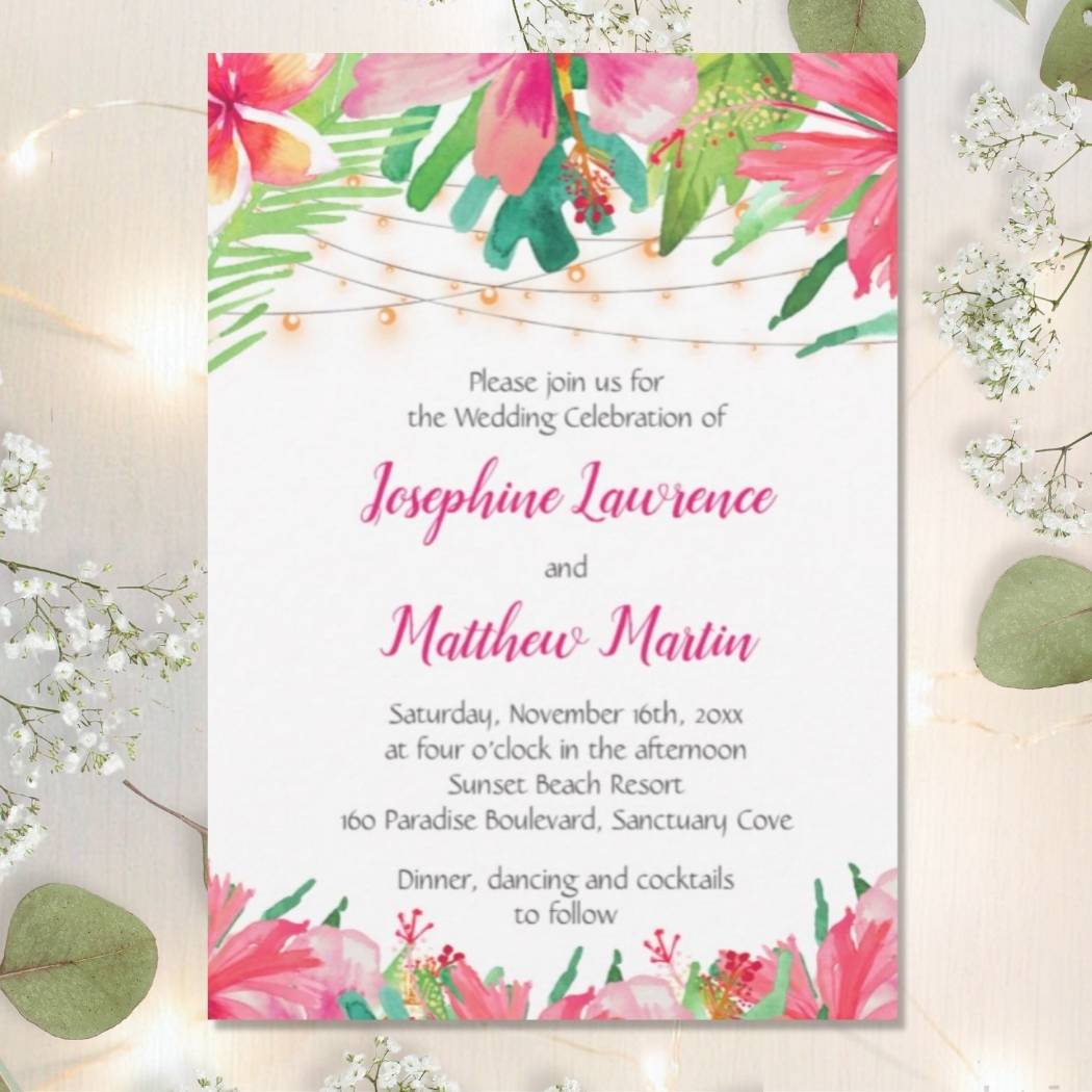 Tropical wedding invitations with watercolor hibiscus flowers and palm leaf foliage.