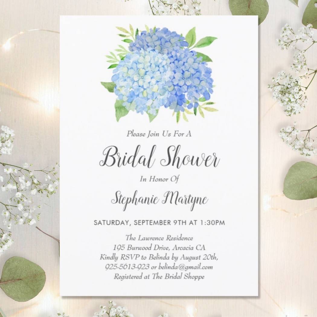 Floral bridal shower invitations with dusty blue watercolor hydrangea flowers and foliage.